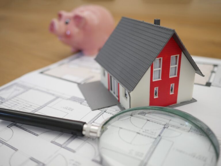 A homeowner reviews a property tax bill while seated at a dining table with papers and a calculator.